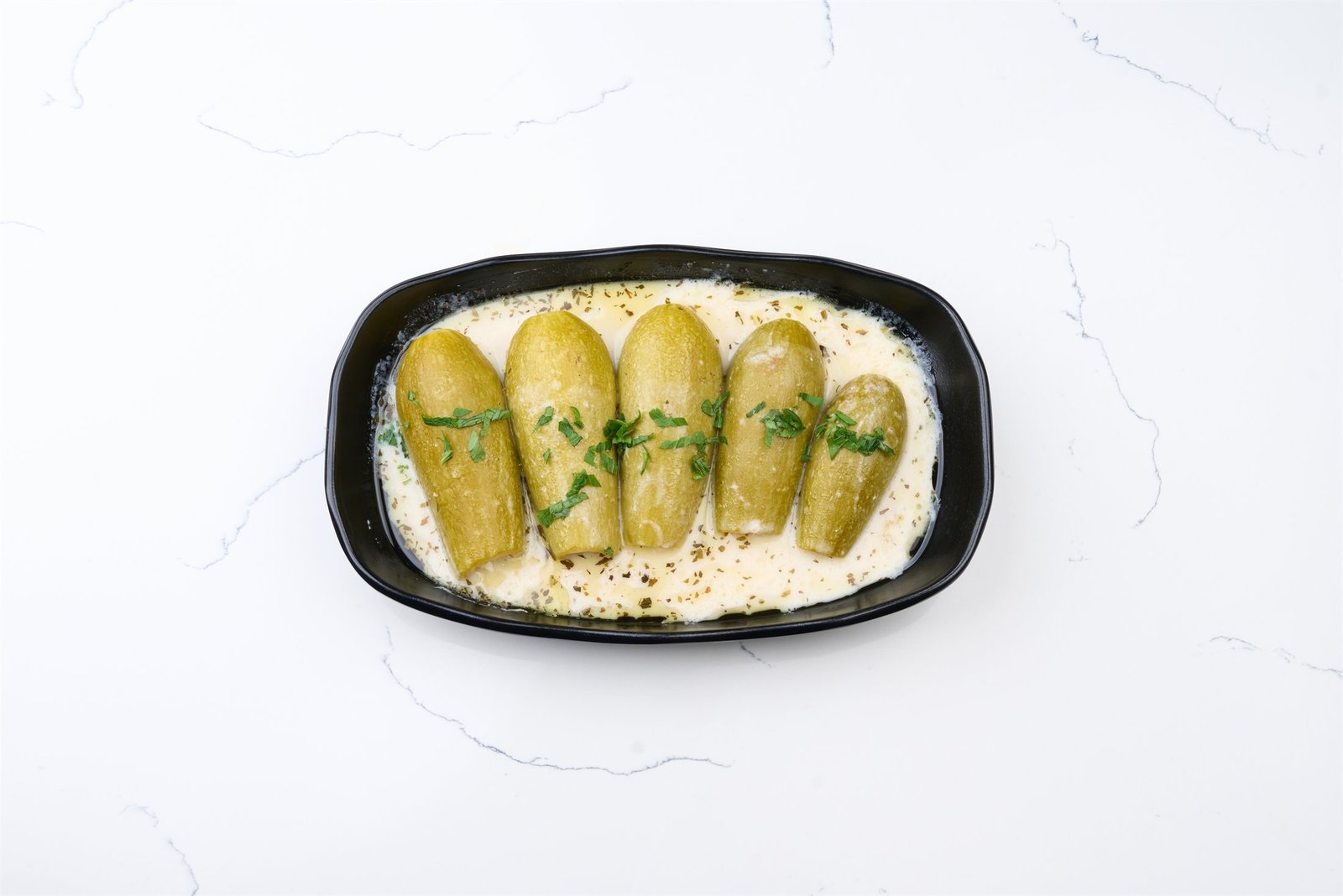 Kousa b Laban stuffed zucchini in yoghurt sauce